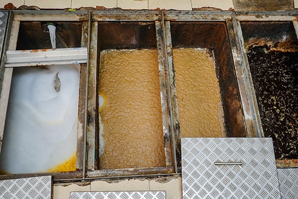 grease trap maintenance typically involves pumping out the accumulated grease, inspecting the trap for any issues, and cleaning the interior